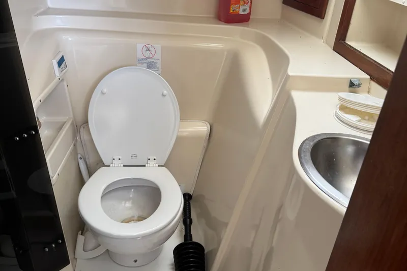 Slide: The Image of Compact bathroom in a 2008 Gemini 105Mc boat with toilet and sink. - 34