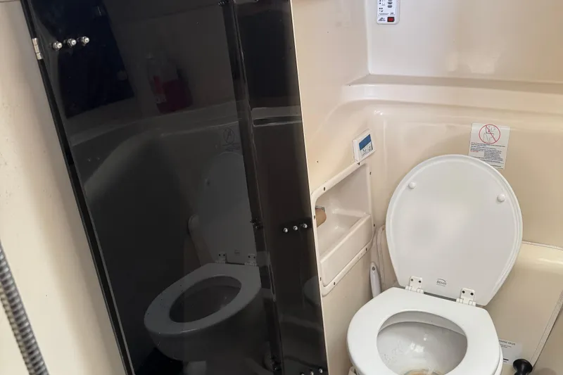 Slide: The Image of 2008 Gemini 105Mc boat bathroom with toilet and shower area. - 35