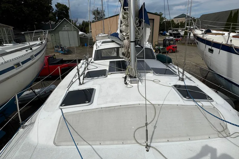 Slide: The Image of 2008 Gemini 105Mc sailboat on land, surrounded by other boats and equipment. - 6