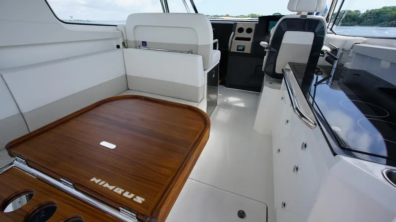 Slide: The Image of Interior of 2025 Nimbus Weekender 11 #60, featuring sleek seating and wooden table. - 12