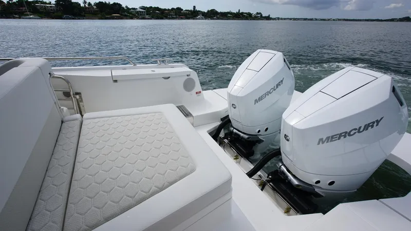 Slide: The Image of Luxury Nimbus Weekender 11 boat with dual Mercury engines on a serene lake, 2025 model. - 19