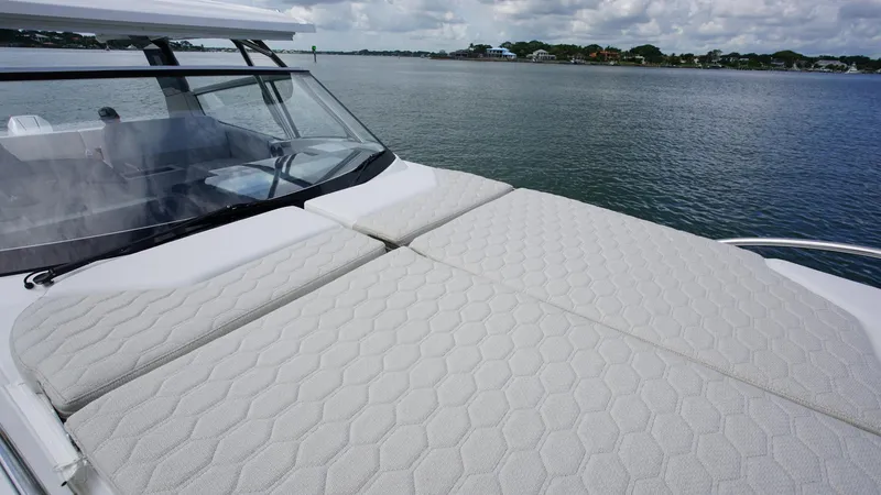 Slide: The Image of Luxurious 2025 Nimbus Weekender 11 yacht with spacious sunbathing deck on calm waters. - 22