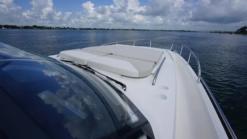 Slide: The Image of Nimbus Weekender 11 #60 boat, 2025 model, cruising on a calm lake under a cloudy sky. - 25