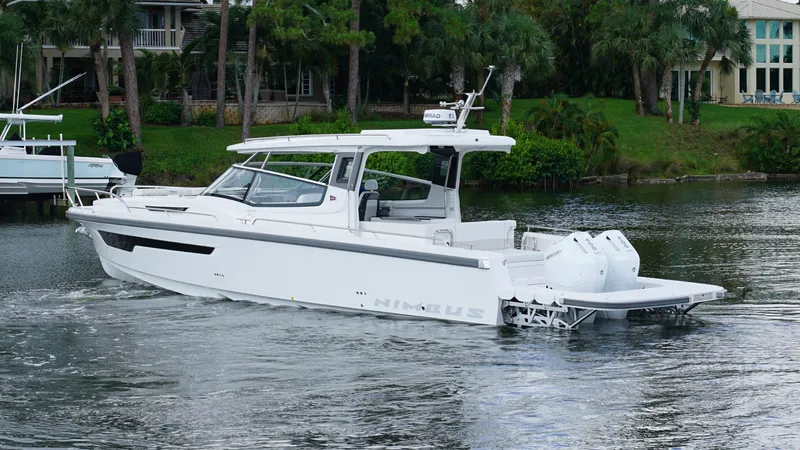 Slide: The Image of 2025 Nimbus Weekender 11 #60 boat cruising on a calm river. - 3