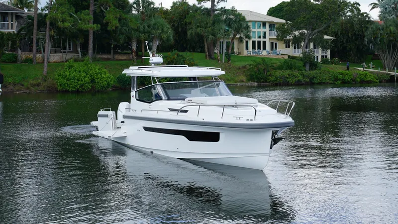 Slide: The Image of 2025 Nimbus Weekender 11 #60 boat cruising on a serene lake. - 2