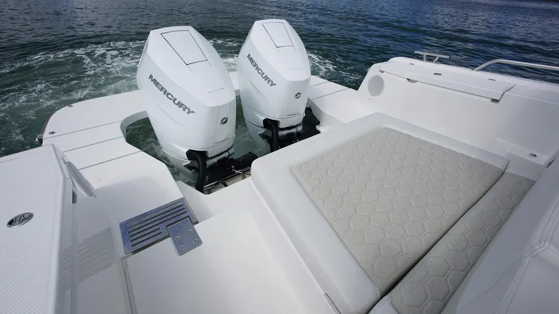 Slide: The Image of 2025 Nimbus Weekender 11 #60 boat with twin Mercury engines and cushioned seating. - 5