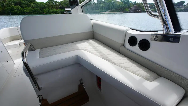 Slide: The Image of Luxurious seating on 2025 Nimbus Weekender 11 #60 boat, with scenic water view. - 9