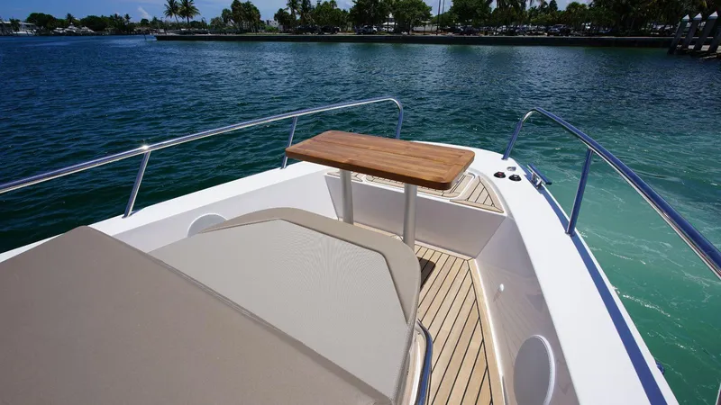 Slide: The Image of Front deck of 2024 Nimbus Commuter 11 #082 boat with table and seating. - 11