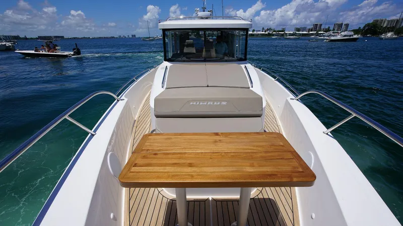 Slide: The Image of 2024 Nimbus Commuter 11 #082 boat with wooden deck table on open water. - 12