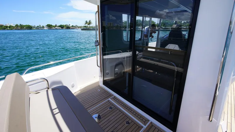 Slide: The Image of 2024 Nimbus Commuter 11 #082 boat deck with seating and sliding glass door. - 14
