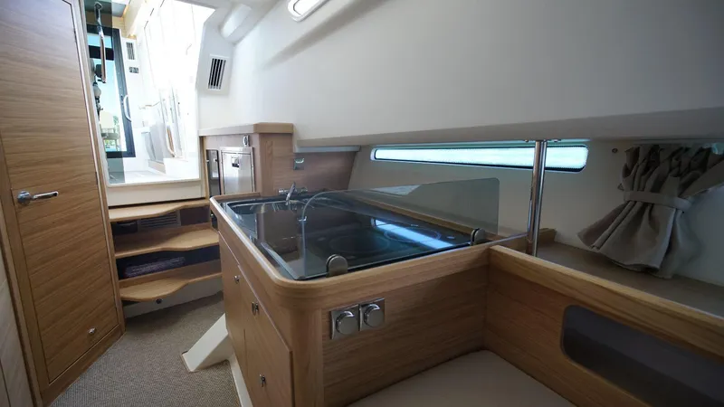 Slide: The Image of Modern kitchen area inside 2024 Nimbus Commuter 11 #082 boat with wooden cabinetry. - 16