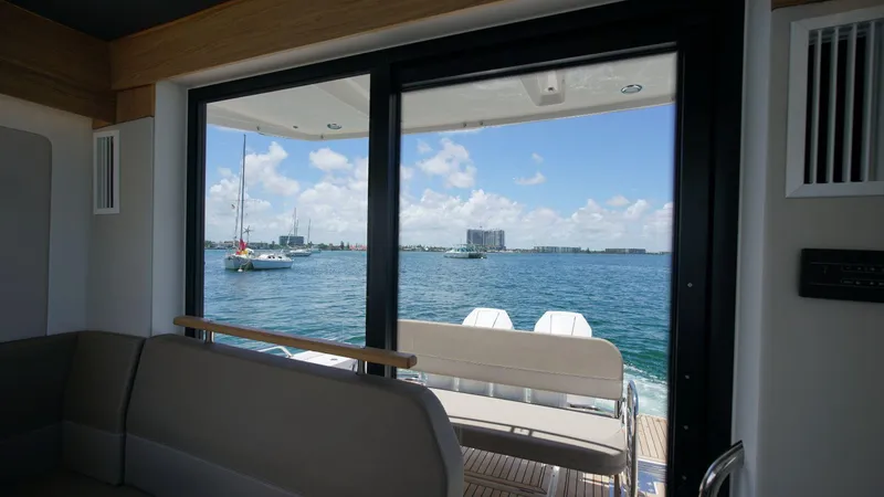 Slide: The Image of View from inside a 2024 Nimbus Commuter 11 #082 boat, overlooking a serene waterfront. - 24