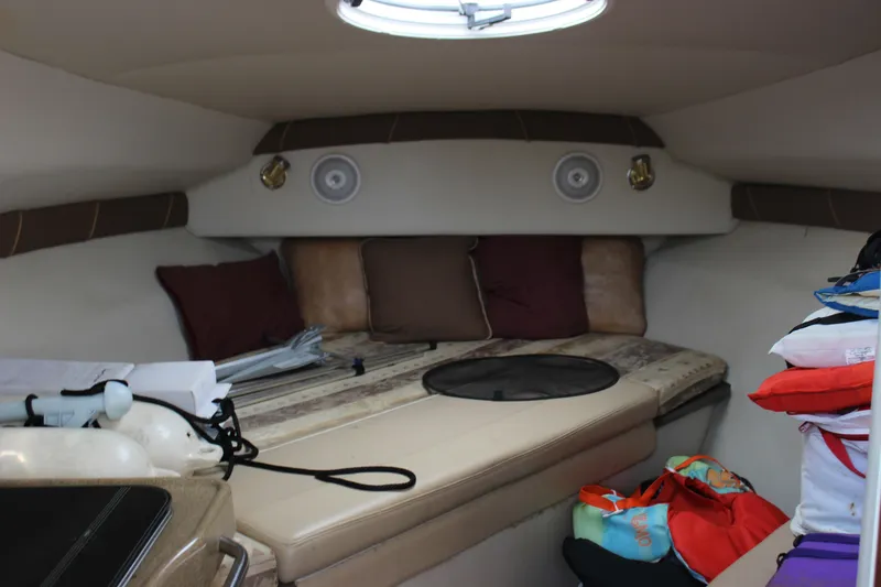 Slide: The Image of Interior cabin of 2003 Wellcraft Martinique 2600 boat with cushions and storage. - 12