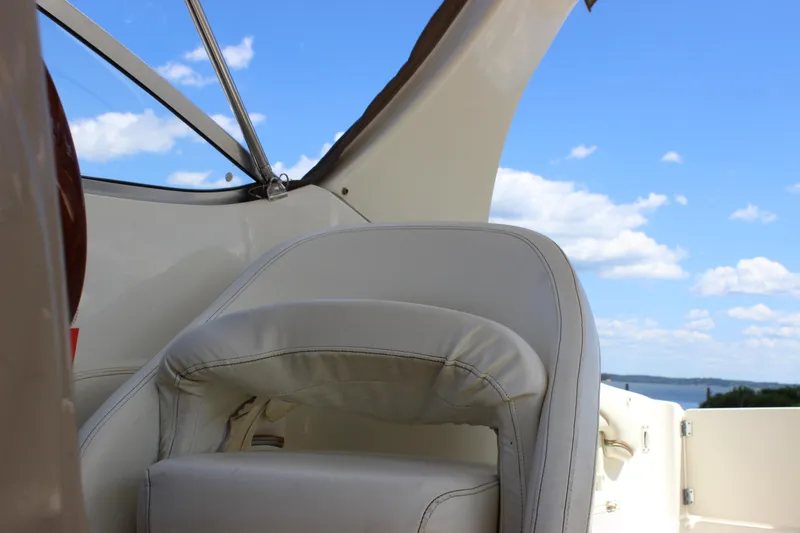 Slide: The Image of 2003 Wellcraft Martinique 2600 boat interior with white seating and blue sky background. - 15