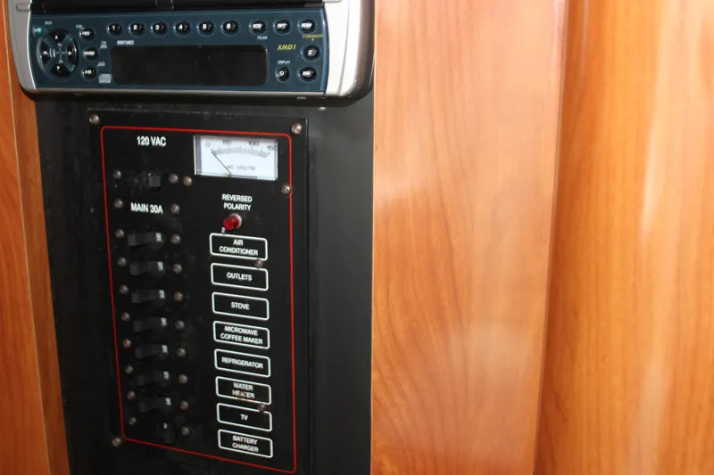 Slide: The Image of Electrical panel and stereo system in 2003 Wellcraft Martinique 2600 boat interior. - 16