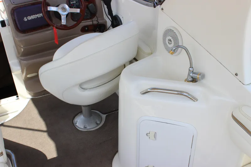 Slide: The Image of 2003 Wellcraft Martinique 2600 interior with helm, white seat, and sink area. - 19