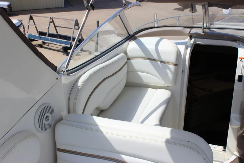 Slide: The Image of 2003 Wellcraft Martinique 2600 boat interior with white seating and open cabin door. - 22