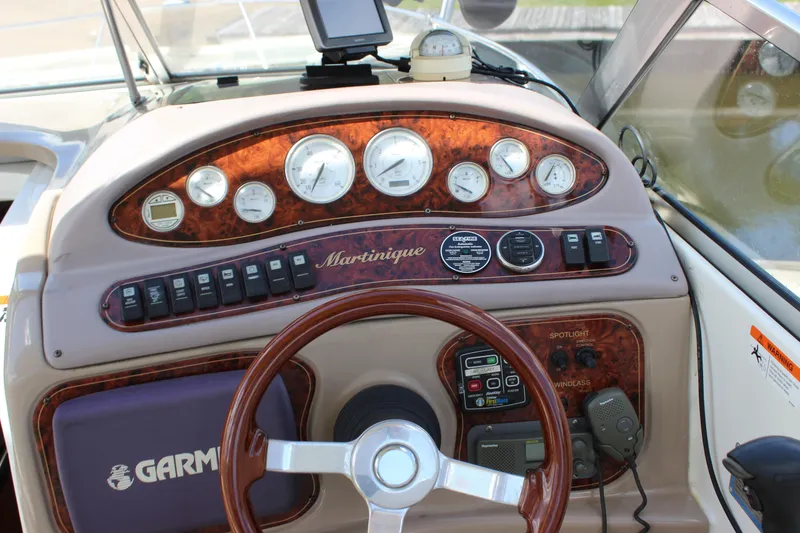 Slide: The Image of 2003 Wellcraft Martinique 2600 boat dashboard with gauges, controls, and Garmin navigation system. - 23