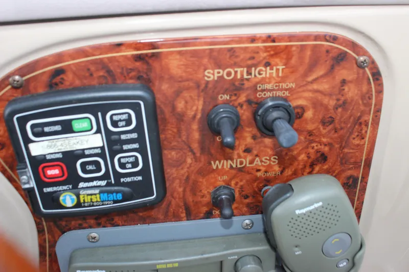Slide: The Image of Control panel of a 2003 Wellcraft Martinique 2600 boat with spotlight and windlass switches. - 25