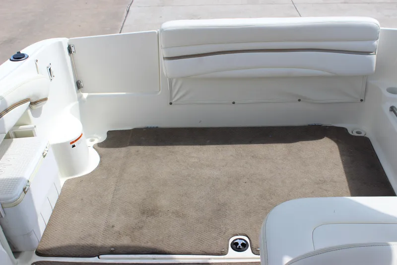 Slide: The Image of 2003 Wellcraft Martinique 2600 boat interior with beige carpet and white seating. - 26