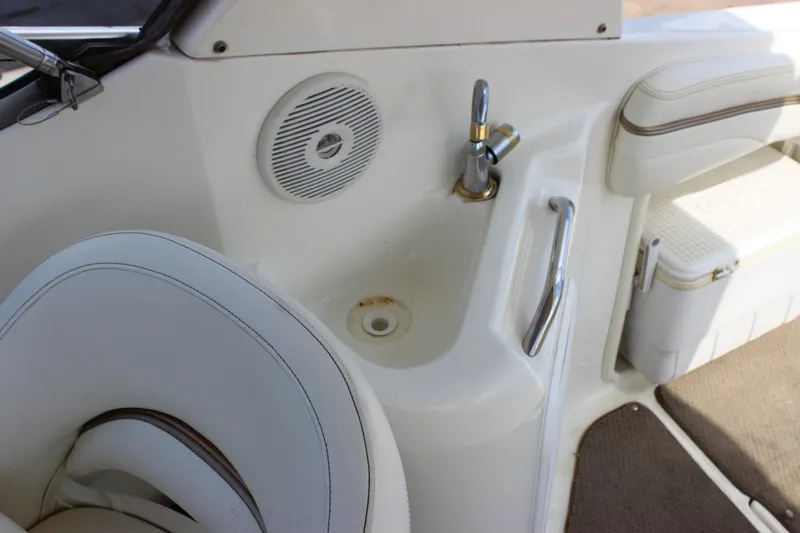 Slide: The Image of 2003 Wellcraft Martinique 2600 boat interior with sink, speaker, and seating area. - 27