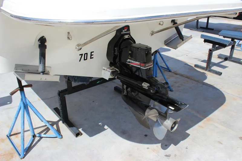 Slide: The Image of 2003 Wellcraft Martinique 2600 boat with Mercury outboard motor on stands. - 4