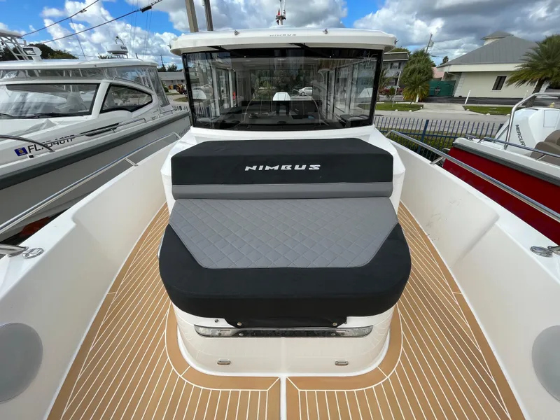 Slide: The Image of 2024 Nimbus Commuter 9 #136 boat with cushioned seating and teak deck. - 14