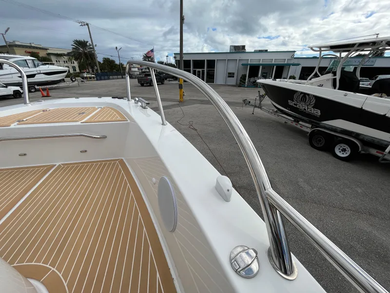 Slide: The Image of 2024 Nimbus Commuter 9 #136 boat deck with stainless steel railings and wood finish. - 17