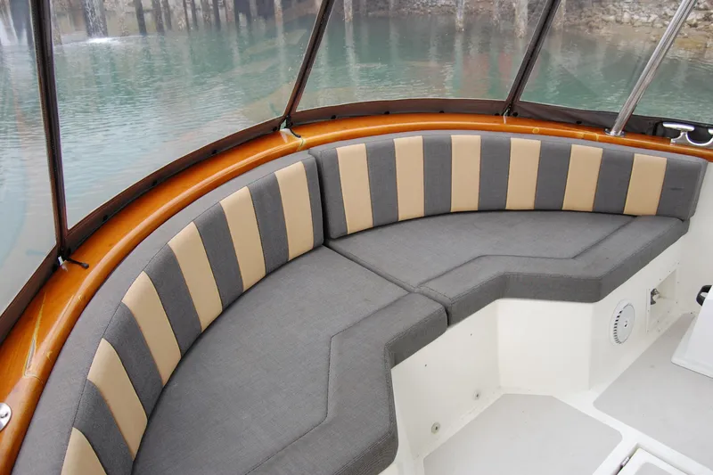 Slide: The Image of 1981 Willard Marine Pilot House Trawler interior with cushioned seating and water view. - 10