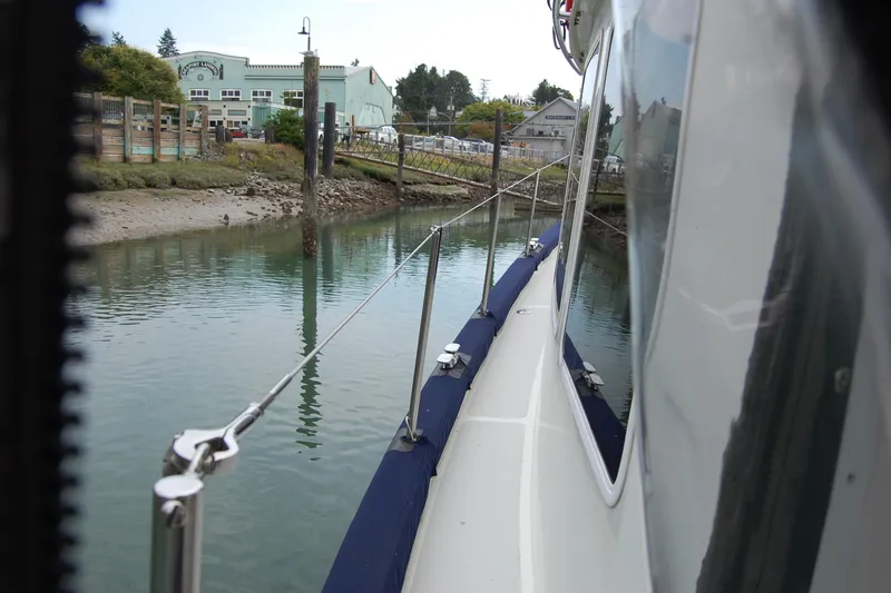 Slide: The Image of 1981 Willard Marine Pilot House Trawler docked near a calm waterfront. - 12