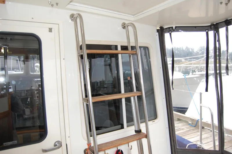 Slide: The Image of 1981 Willard Marine Pilot House Trawler interior with ladder and window view. - 15