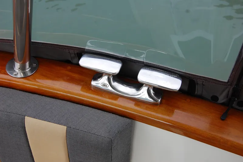 Slide: The Image of Close-up of 1981 Willard Marine Pilot House Trawler's polished metal cleat and wooden trim. - 18