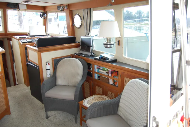 Slide: The Image of Interior of 1981 Willard Marine Pilot House Trawler with seating, lamp, and navigation equipment. - 19