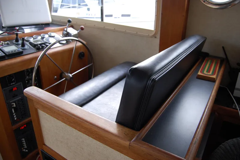 Slide: The Image of 1981 Willard Marine Pilot House Trawler interior with steering wheel and control panel. - 22