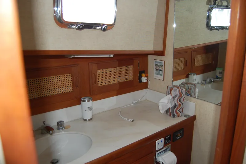 Slide: The Image of 1981 Willard Marine Pilot House Trawler bathroom with wooden cabinetry and sink. - 30