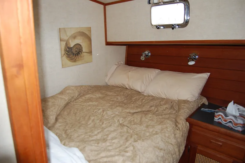Slide: The Image of Cozy cabin bedroom in 1981 Willard Marine Pilot House Trawler with nautical decor. - 32