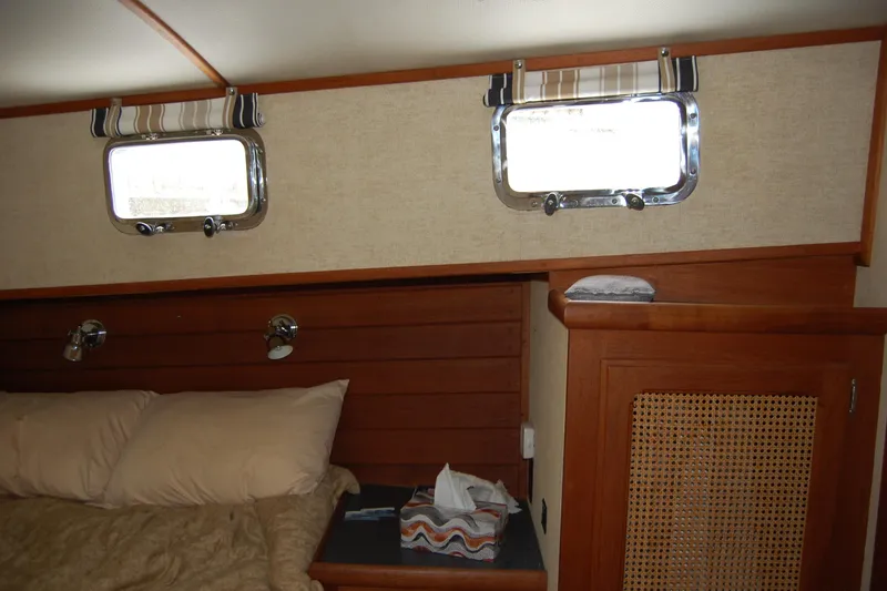 Slide: The Image of Cozy cabin interior of 1981 Willard Marine Pilot House Trawler with wooden accents and porthole windows. - 33