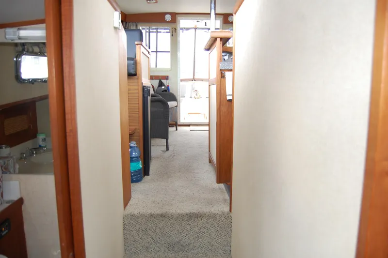 Slide: The Image of Interior view of 1981 Willard Marine Pilot House Trawler, featuring hallway and seating area. - 36