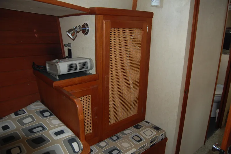 Slide: The Image of 1981 Willard Marine Pilot House Trawler interior with wood paneling and patterned cushions. - 39