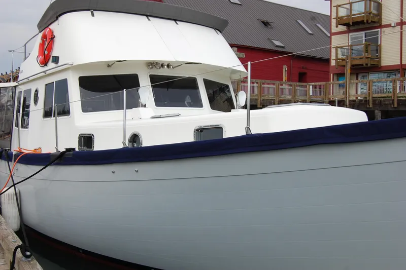 Slide: The Image of 1981 Willard Marine Pilot House Trawler docked at a marina. - 4
