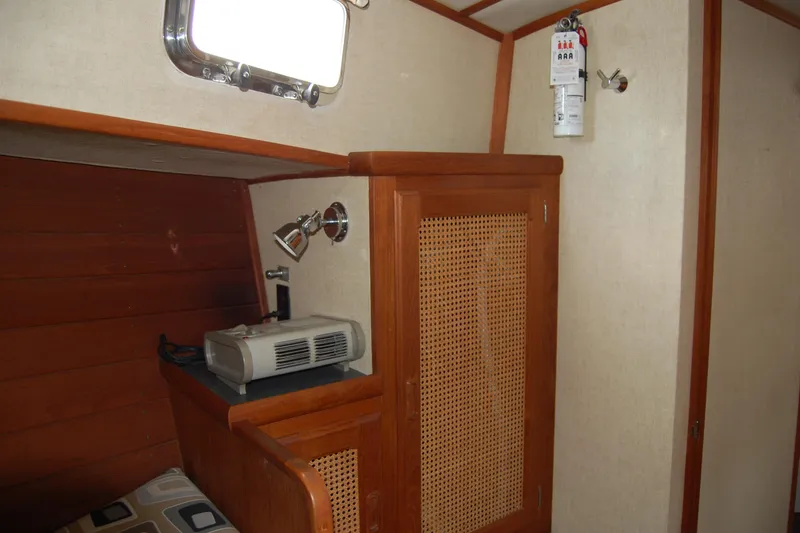 Slide: The Image of 1981 Willard Marine Pilot House Trawler interior with wood paneling and fire extinguisher. - 40