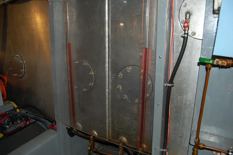 Slide: The Image of Engine room of 1981 Willard Marine Pilot House Trawler with visible pipes and wiring. - 45