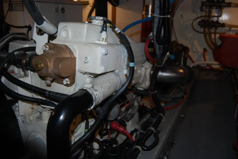 Slide: The Image of Engine room of 1981 Willard Marine Pilot House Trawler with visible machinery and wiring. - 46