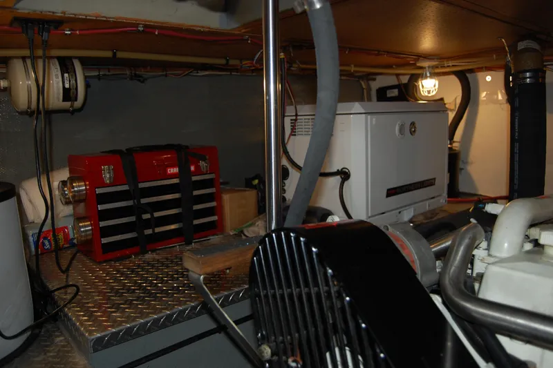 Slide: The Image of Engine room of 1981 Willard Marine Pilot House Trawler with tools and equipment. - 48