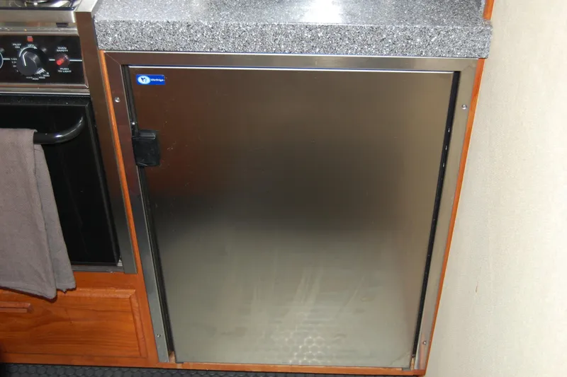 Slide: The Image of Stainless steel refrigerator in 1981 Willard Marine Pilot House Trawler kitchen. - 52