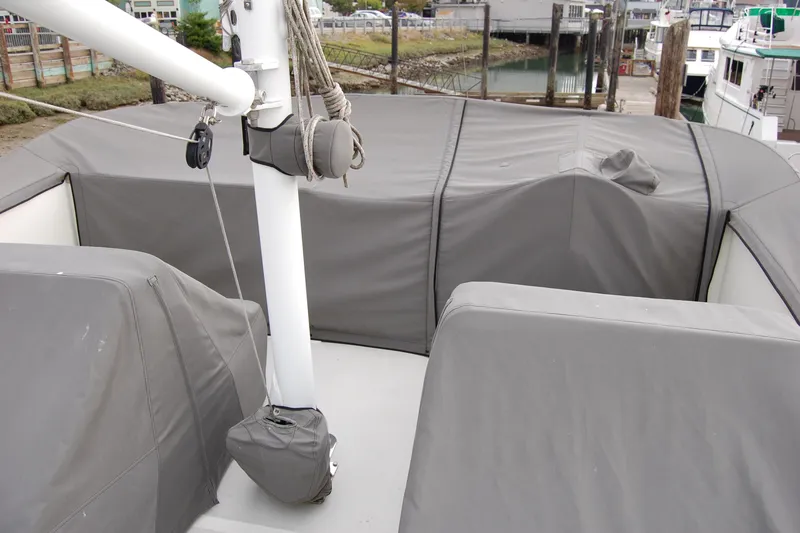 Slide: The Image of 1981 Willard Marine Pilot House Trawler deck with protective covers in a marina setting. - 54