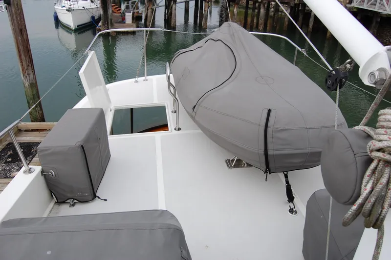 Slide: The Image of 1981 Willard Marine Pilot House Trawler deck with covered equipment and dock view. - 56
