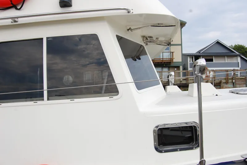 Slide: The Image of 1981 Willard Marine Pilot House Trawler, side view with windows and railing. - 6