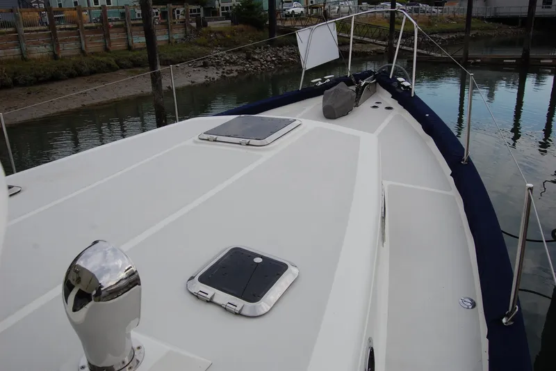 Slide: The Image of 1981 Willard Marine Pilot House Trawler deck with hatches, docked in a marina. - 60