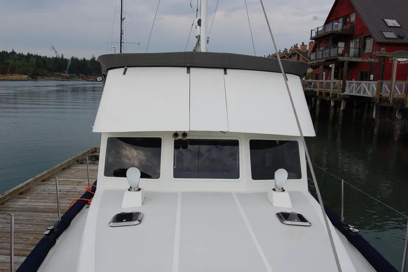 Slide: The Image of 1981 Willard Marine Pilot House Trawler docked near waterfront buildings. - 61